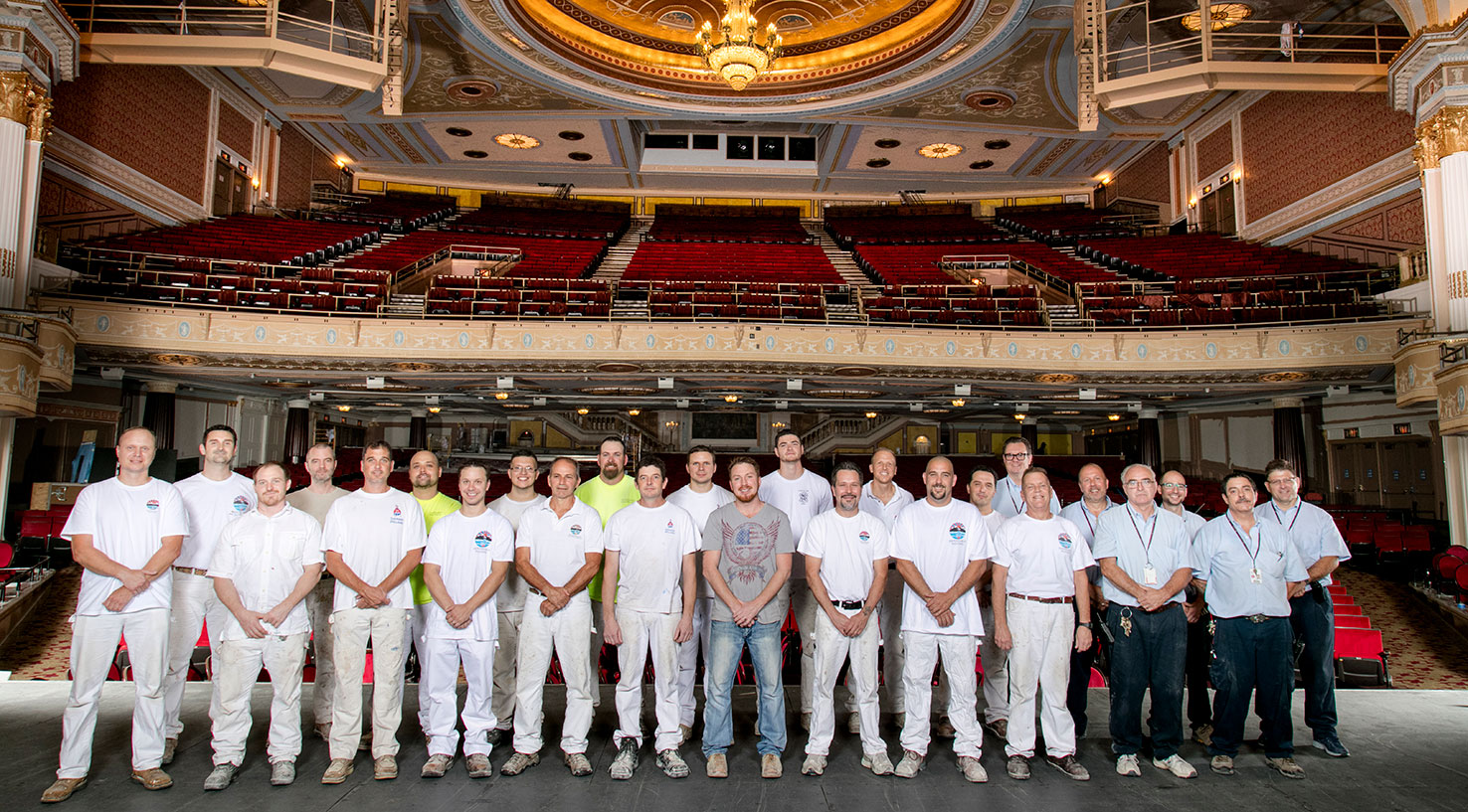 The State Theatre restoration was a collaborative effort of EverGreene Architectural Arts of New York and The Dependable Painting Company of Cleveland. Paint crews of the two firms pose on the stage with the Playhouse Square facilities staff